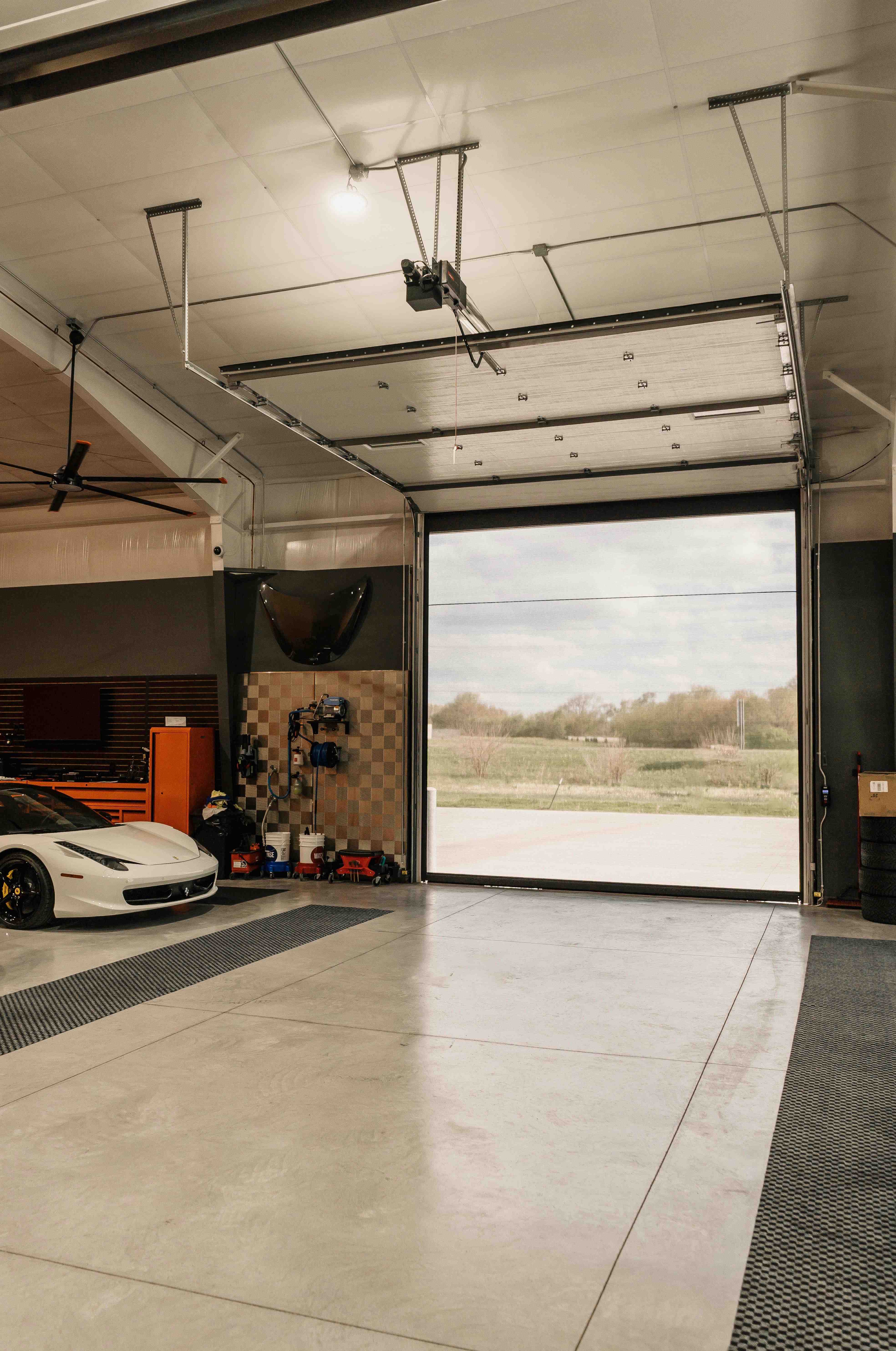 Large motorized screen lowered in an oversized overhead shop door